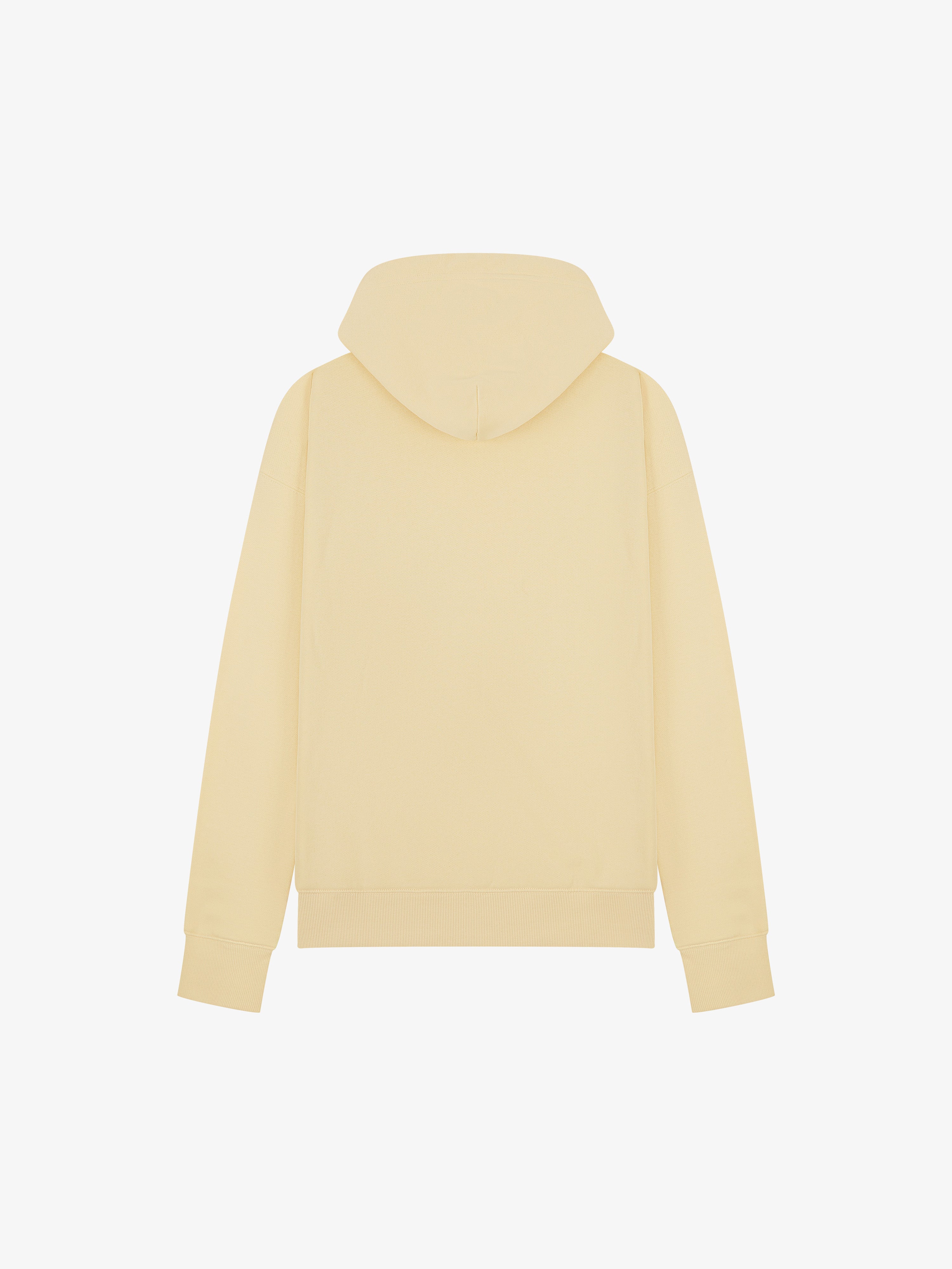 Back view of the Sunny Yellow Organic Cotton Hoodie by LoveYouAll, showcasing the relaxed fit and ribbed hem.