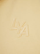 Close-up of soft organic cotton fabric on yellow hoodie