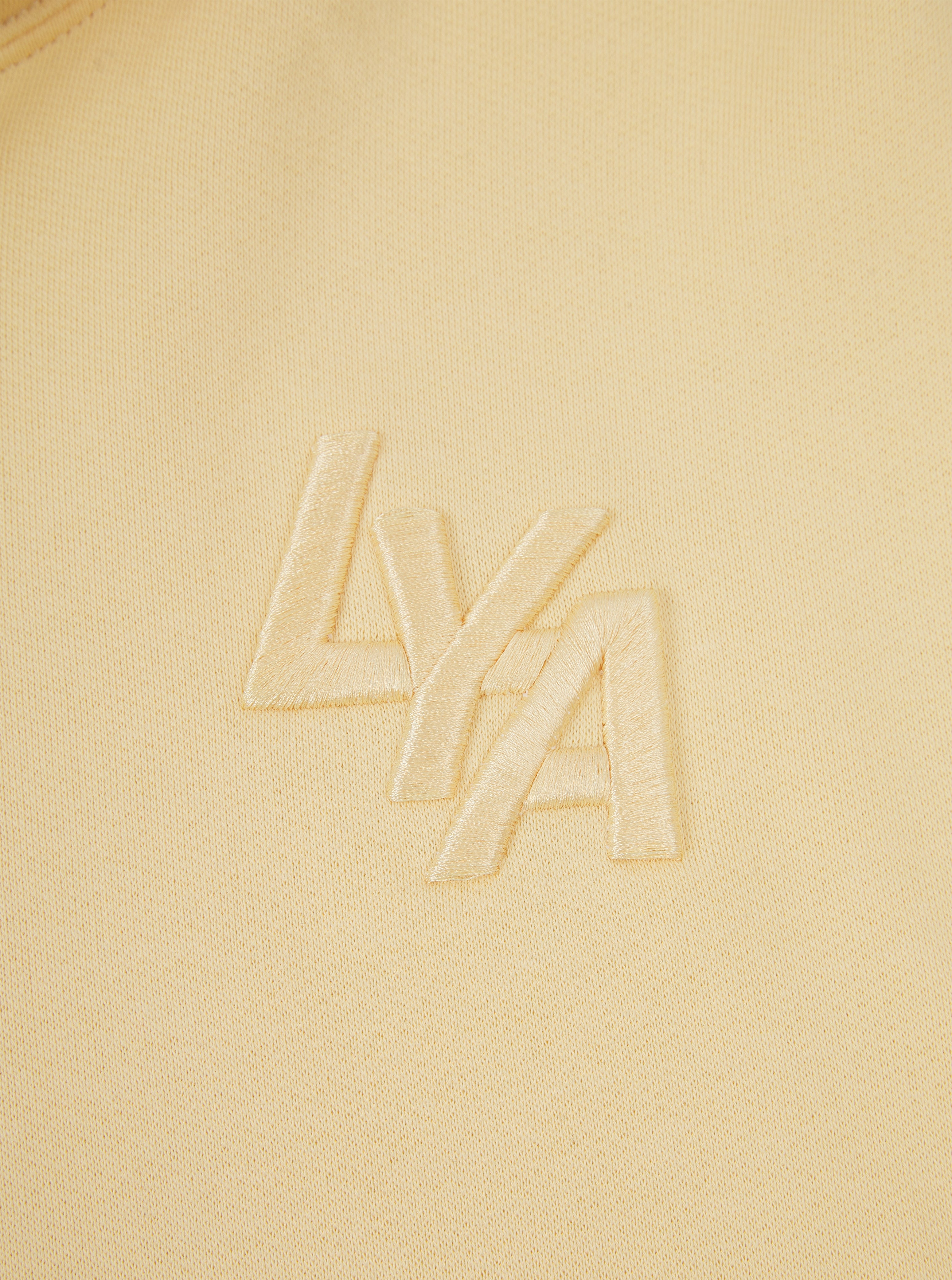 Close-up of soft organic cotton fabric on yellow hoodie